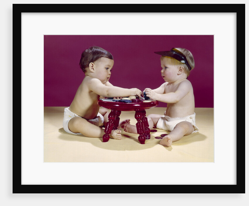 1960s two babies sitting at red stool playing cards poker with gambling chips by Anonymous