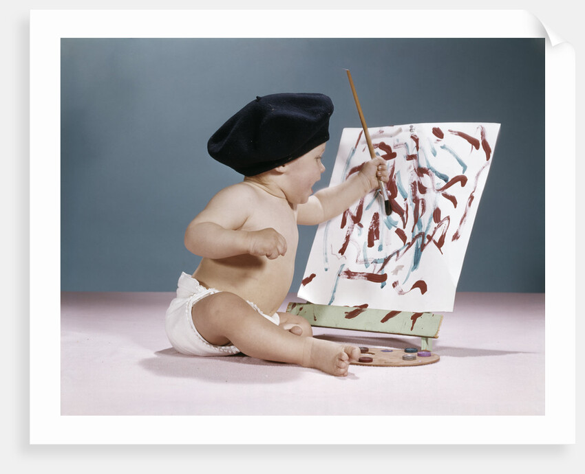 1960s baby artist wearing black beret sitting in front of easel painting by Anonymous