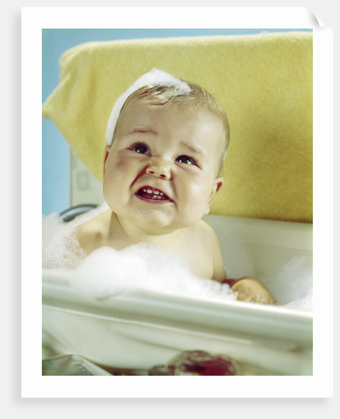 1960s smiling baby in bath looking up by Anonymous
