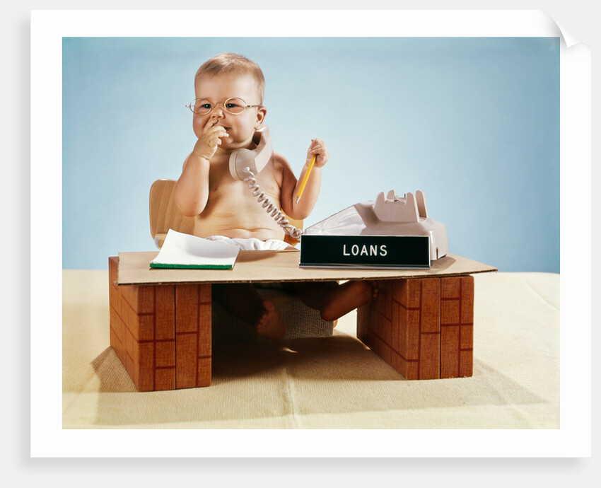 1960s baby businessman diaper sitting at loan desk wearing eyeglasses talking on telephone by Anonymous