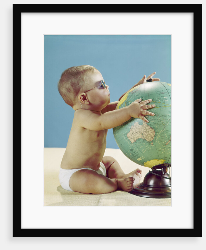 1960s baby wearing eyeglasses hugging the world globe earth by Anonymous