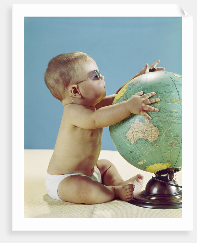 1960s baby wearing eyeglasses hugging the world globe earth by Anonymous