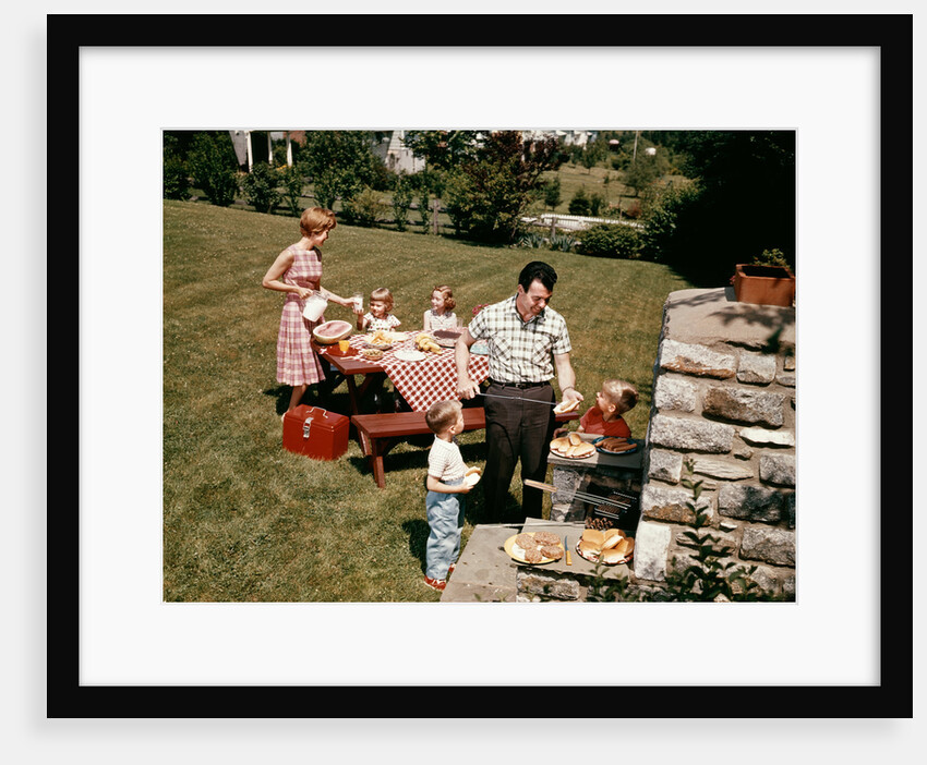 1960s family father mother two daughters two sons backyard bar-b-cue outdoor by Anonymous