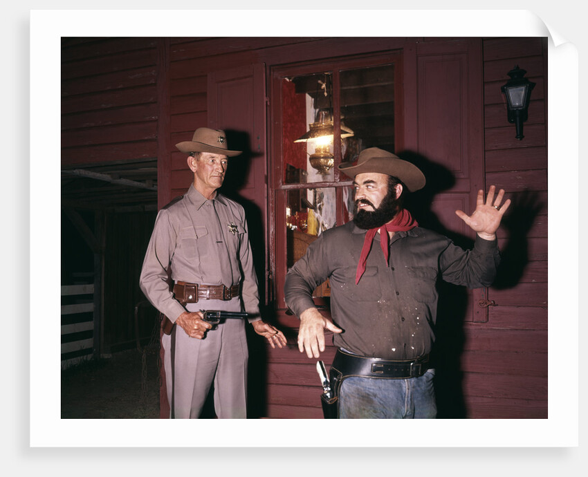 1960s 1970s western sheriff arrests bearded cowboy about to draw gun by Anonymous
