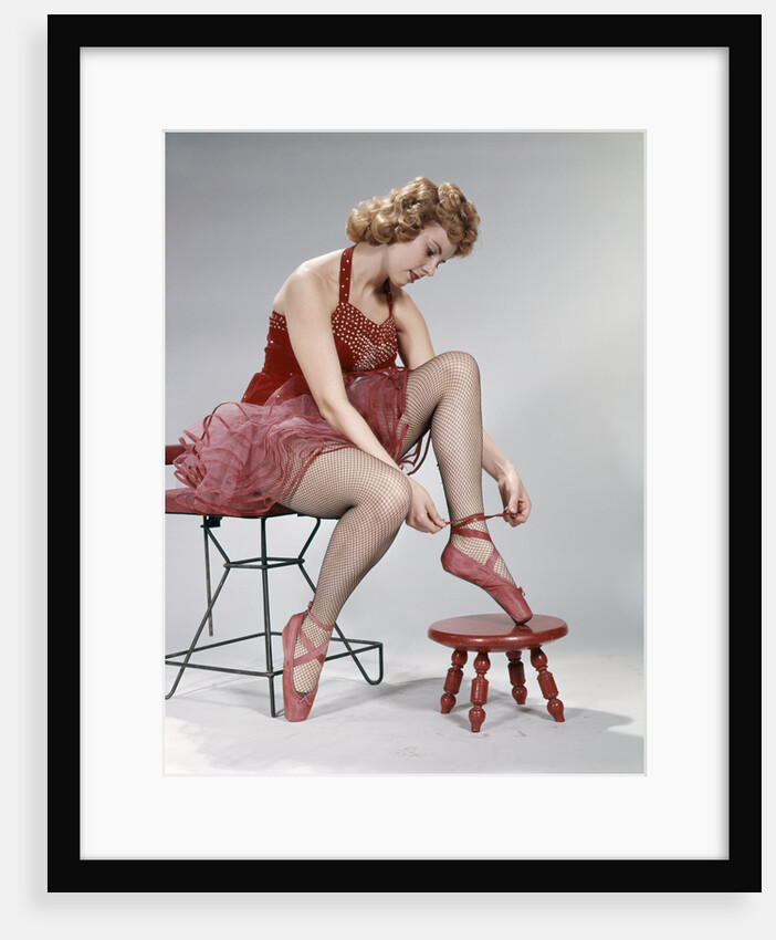 1960s teen girl woman red velvet costume pink net tutu foot stool tie ballet slipper shoe fishnet stockings by Anonymous