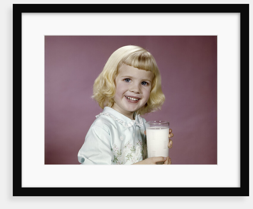 1960s girl glass milk dairy smile looking at camera by Anonymous