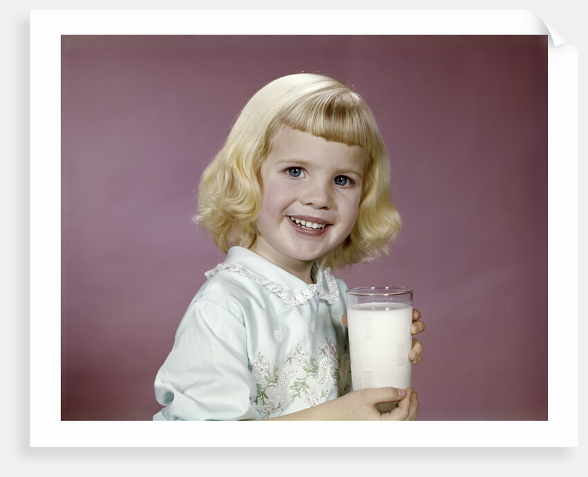 1960s girl glass milk dairy smile looking at camera by Anonymous