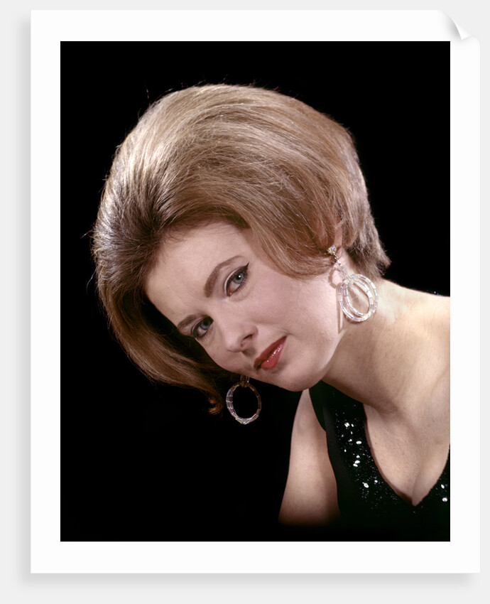 1960s portrait serious woman black sequin evening diamond earrings dress bouffant hairstyle looking at camera by Anonymous