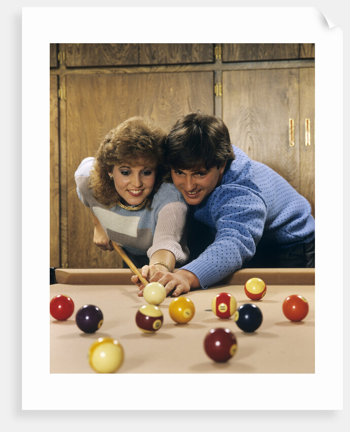 1980s teen couple playing pool by Anonymous