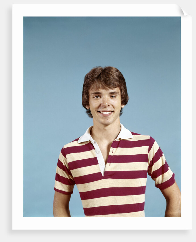 1970s portrait of smiling teenage boy wearing striped rugby shirt looking at camera by Anonymous