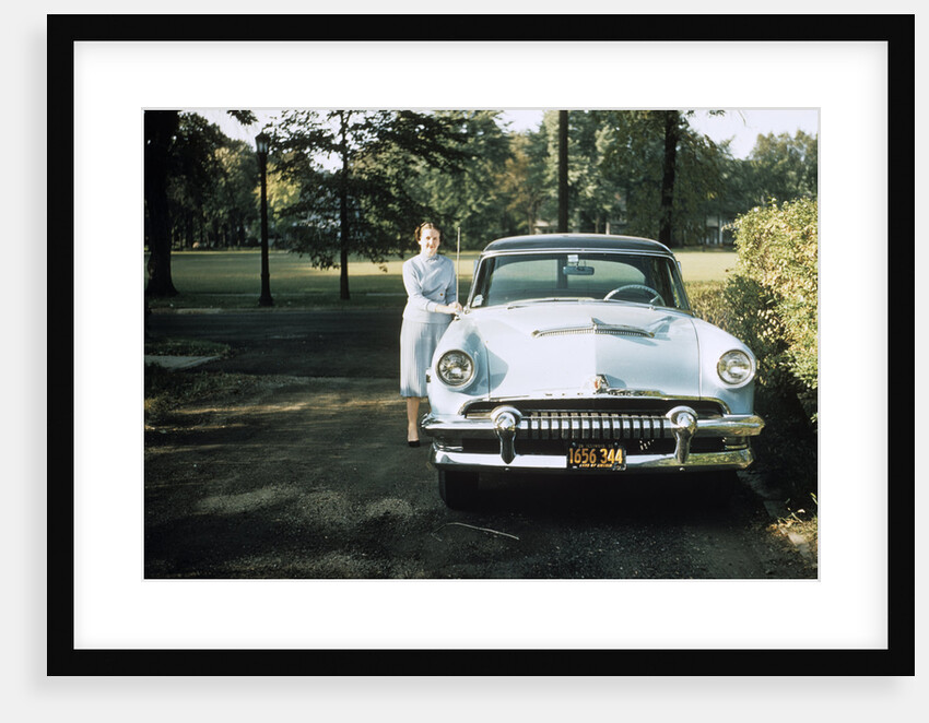 1950s 1955 woman standing beside 1954 mercury automobile by Anonymous