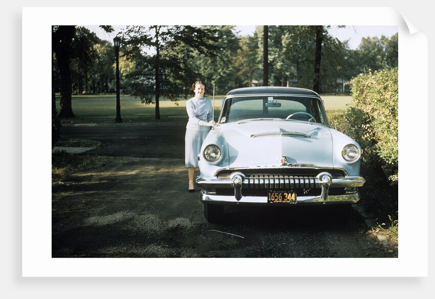 1950s 1955 woman standing beside 1954 mercury automobile by Anonymous