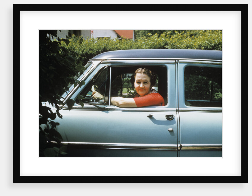 1950s woman driver looking out of car window by Anonymous
