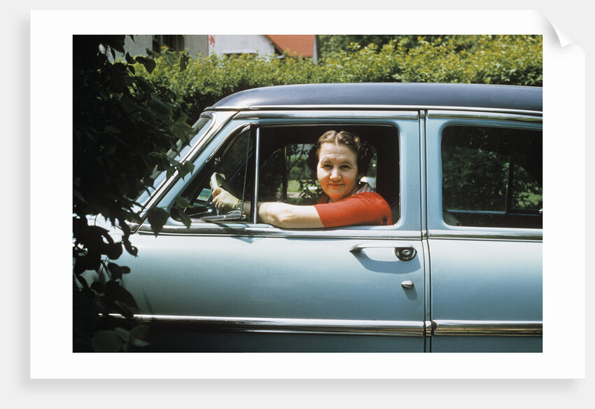 1950s woman driver looking out of car window by Anonymous
