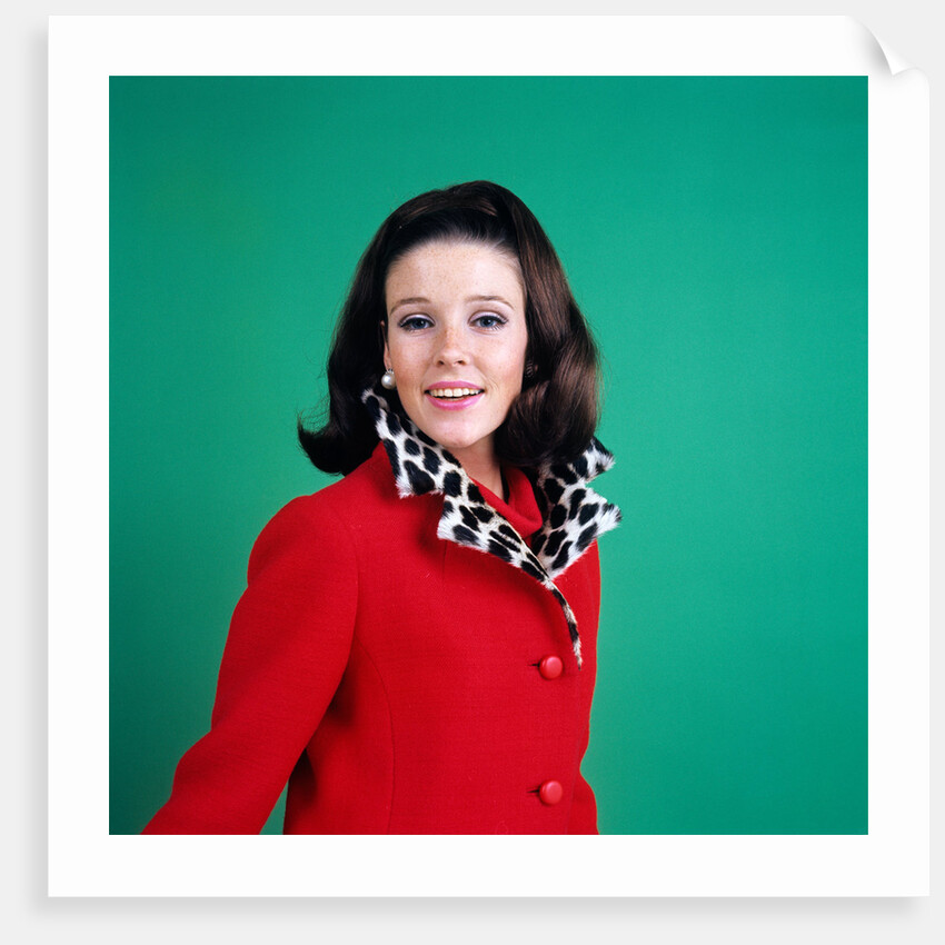 1960s smiling young woman brunette red coat leopard skin fur collar by Anonymous