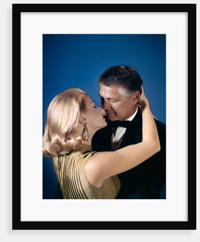 Romantic couple embracing about to kiss husband wife evening dress studio 1970s 1960s by Anonymous
