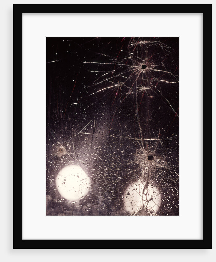 1970s bullet holes and raindrops on shattered glass windshield by Anonymous