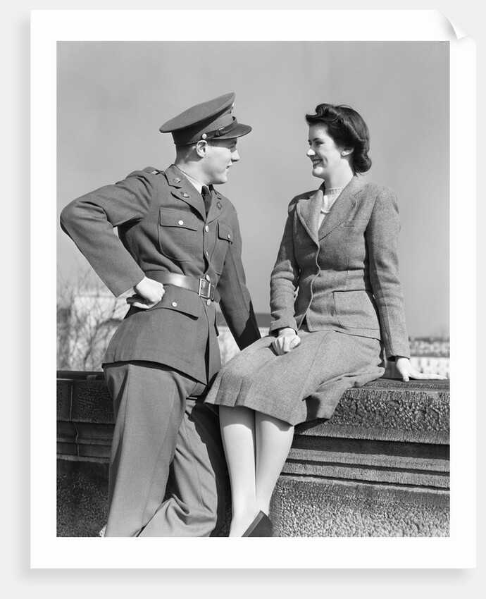 1940s happy couple man wearing army uniform woman sitting on stone wall by Anonymous