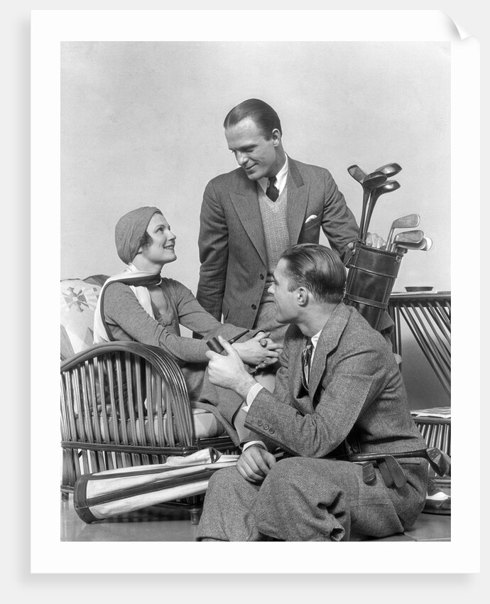 1930s two men one woman golf clubs bag smiling talking sitting bamboo chair man smoking pipe by Anonymous
