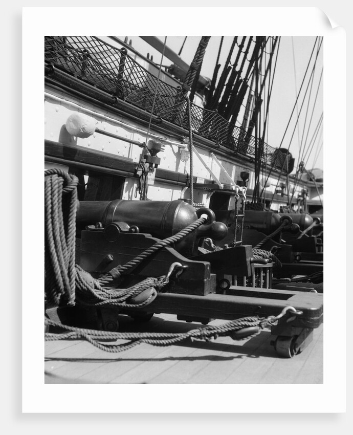 1930s row of cannon breeches on gun deck of sailing naval ship of war by Anonymous