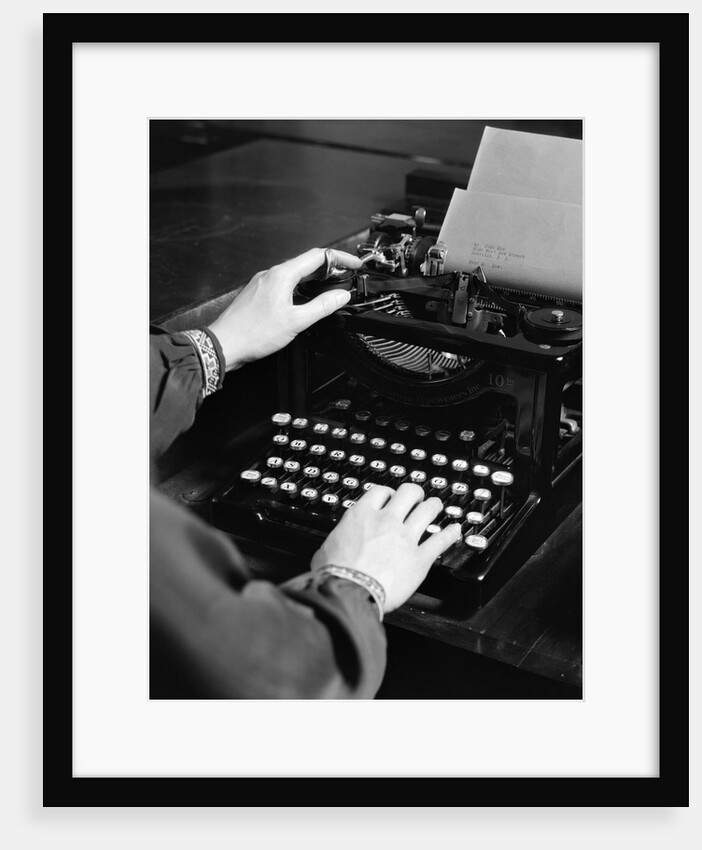 1930s woman's hands typing business letter at manual typewriter by Anonymous