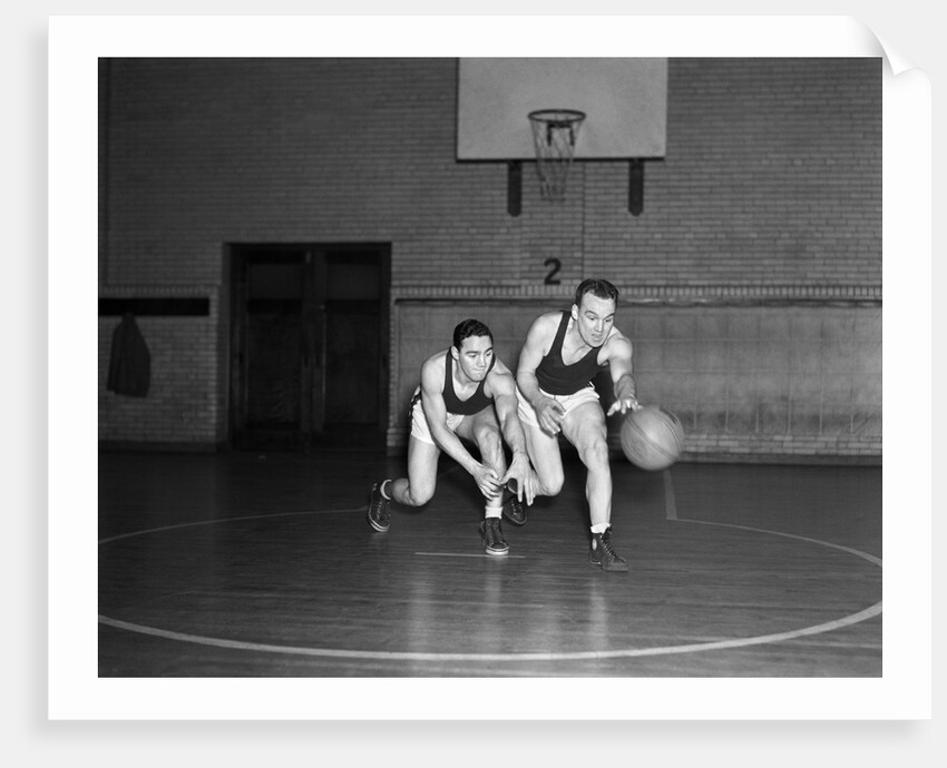 1930s two boys playing basketball inside court dribbling basketball by Anonymous