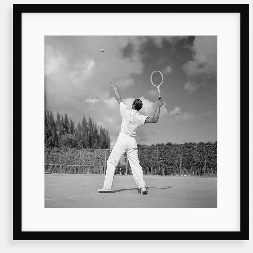 1930s back view of man playing tennis about to hit the ball summer outdoor by Anonymous