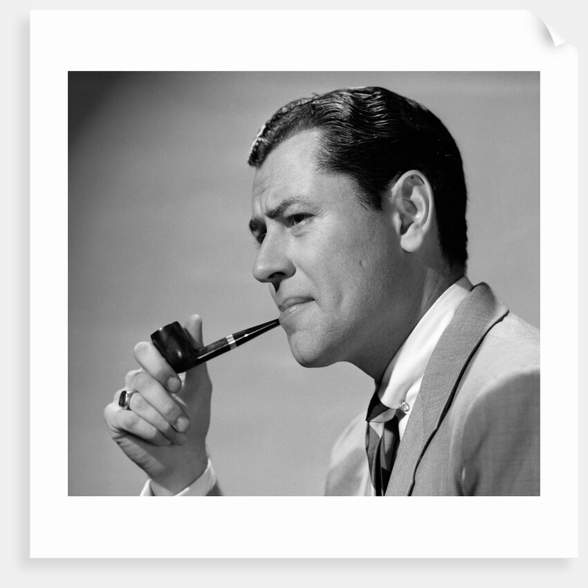 1950s frowning businessman in jacket and tie smoking a pipe by Anonymous