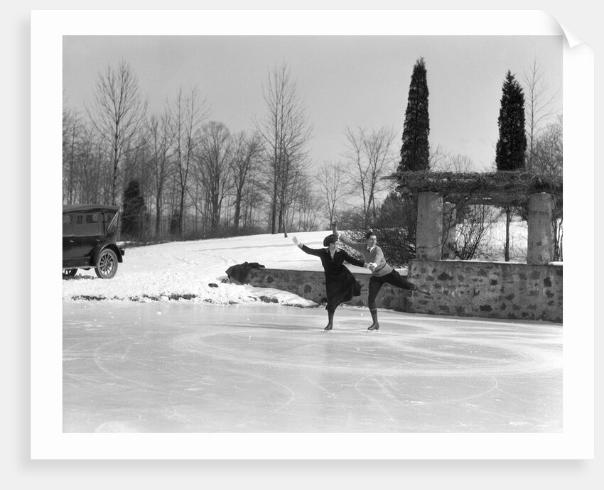 1920s couple man woman ice skating on outdoor rink with car nearby skating side by side by Anonymous