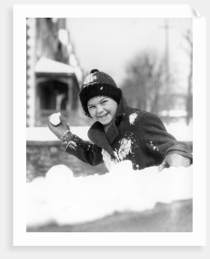 1920s 1930s smiling boy about to throw toss snowball playing snow fun winter cold mischief looking at camera by Anonymous