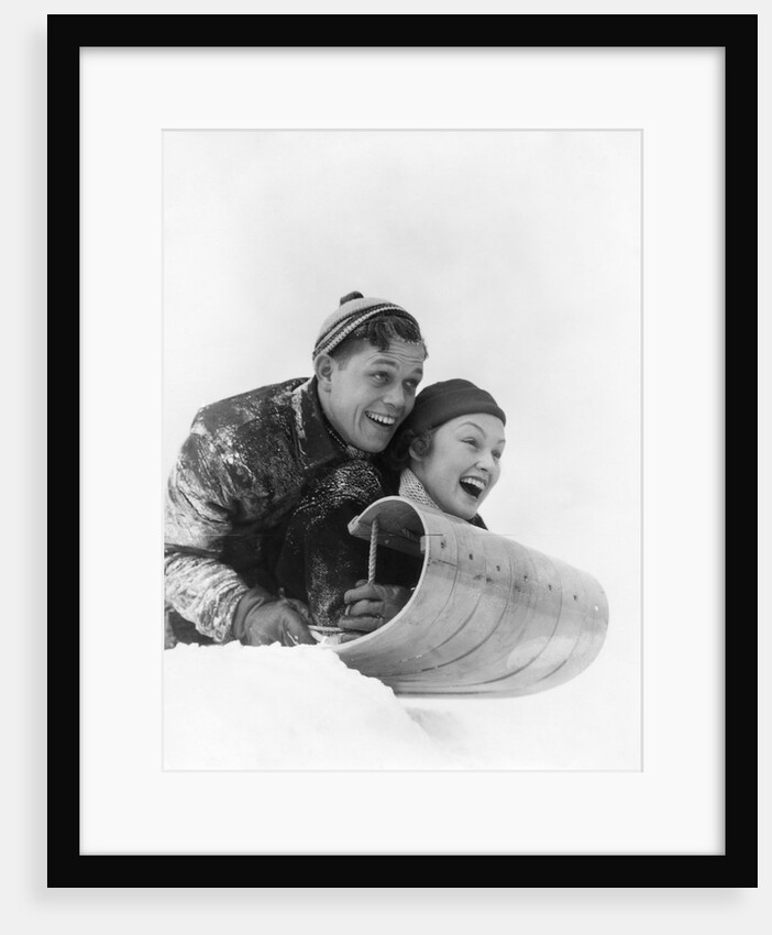 1930s couple on toboggan laughing by Anonymous