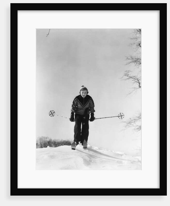 1930s woman holding ski poles skiing in snow by Anonymous