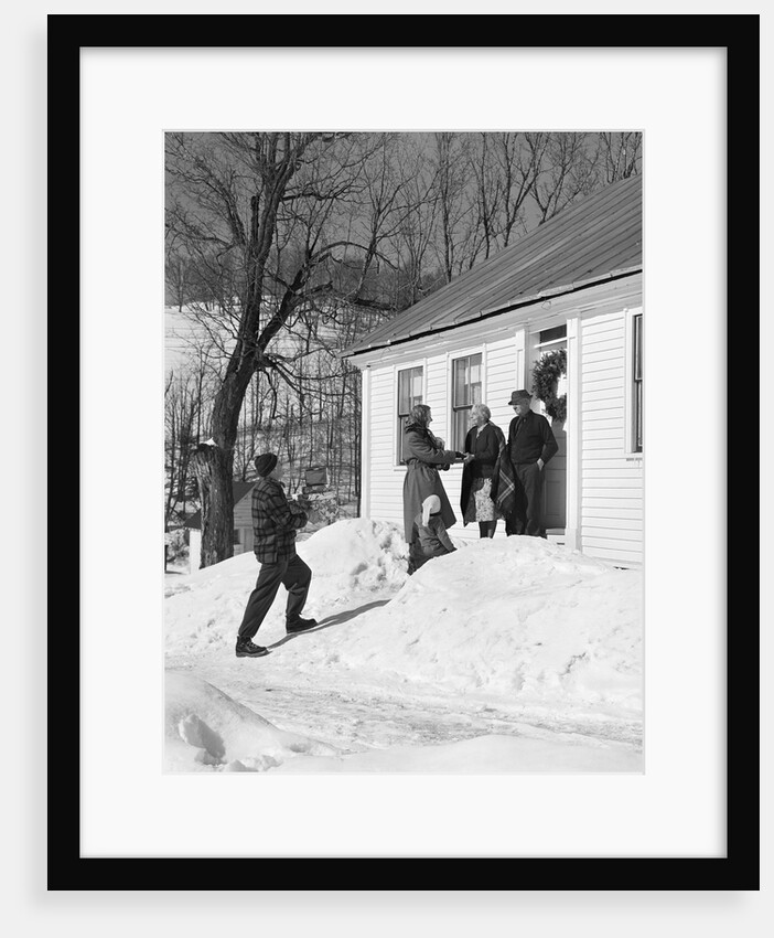1950s family visiting relatives at christmas being greeted at front door by Anonymous