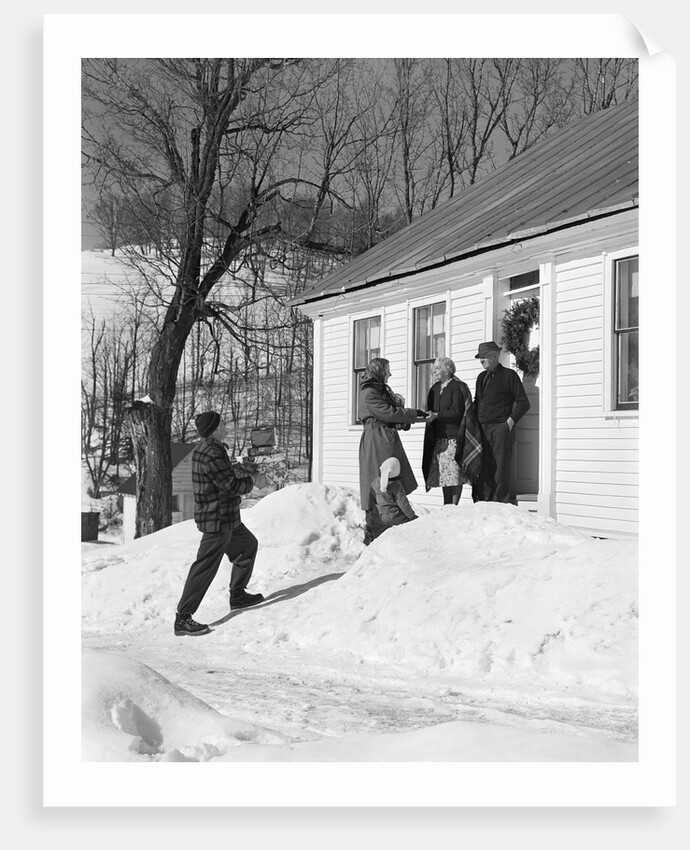 1950s family visiting relatives at christmas being greeted at front door by Anonymous