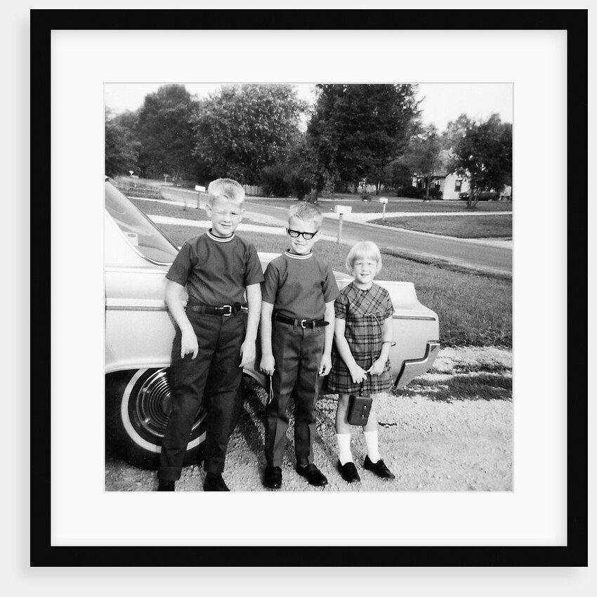 A lineup of kids by the family car. 1965. by Anonymous