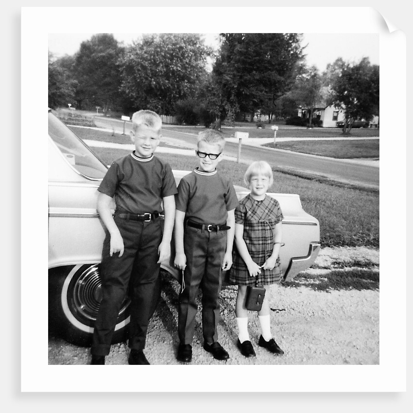 A lineup of kids by the family car. 1965. by Anonymous