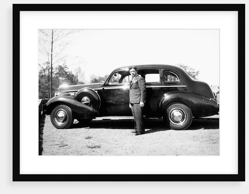 Mature man with his new automobile, ca. 1940 by Anonymous