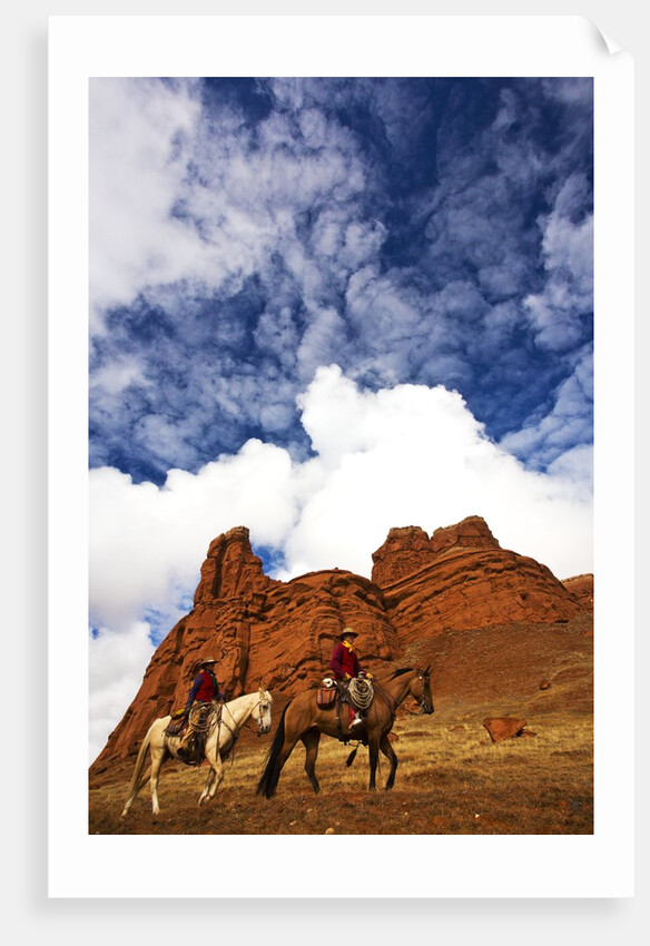 Riders passing under the Red Rock Hills of the Big Horn Mountains by Anonymous