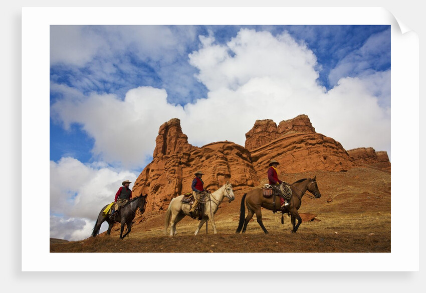 Riders passing under the Red Rock Hills of the Big Horn Mountains by Anonymous