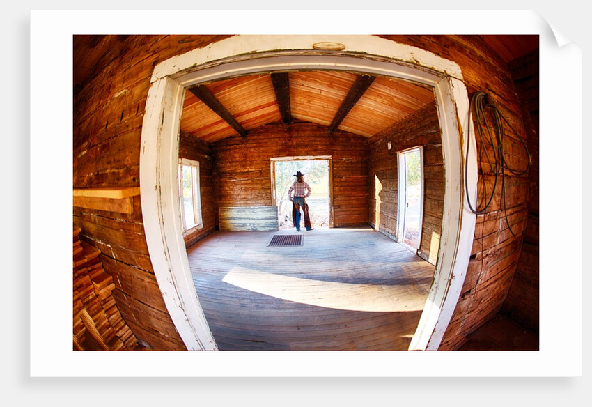 Cowgirl in doorway of old cabin by Anonymous
