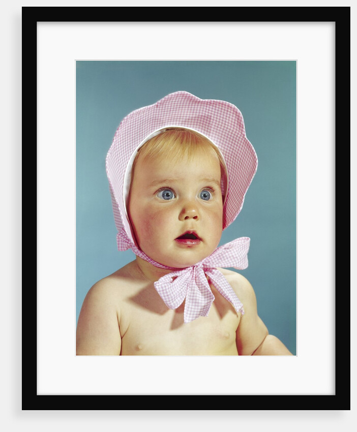 1960s Very Cute Blond Blue Eyed Baby Wearing Red White Checked Bonnet Tied In Bow At Chin by Anonymous