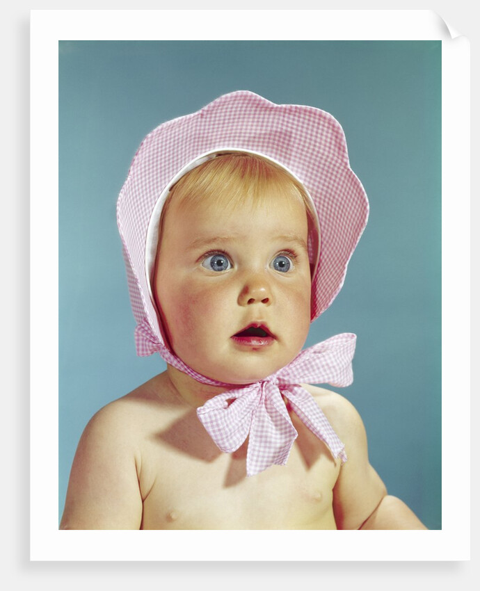 1960s Very Cute Blond Blue Eyed Baby Wearing Red White Checked Bonnet Tied In Bow At Chin by Anonymous