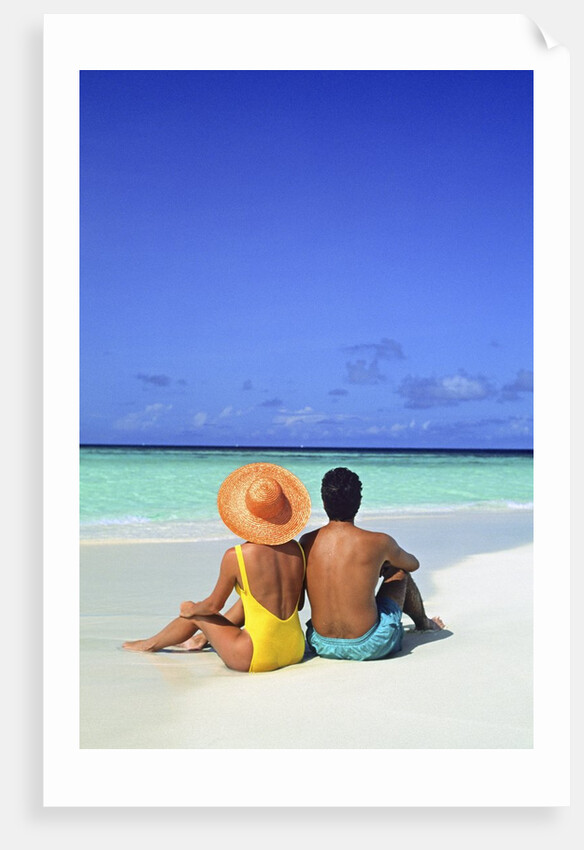 1990s Man And Woman Sitting On The Beach Facing The Water Mopion Island, Grenadines, West Indies by Anonymous