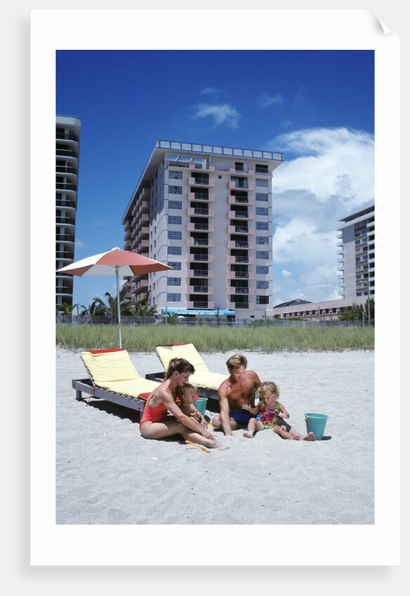 1990s Young Family On Beach Playing In The Sand by Anonymous