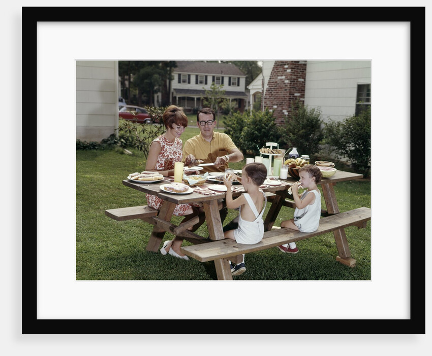 1960s Family Of Four At Backyard Picnic Table by Anonymous