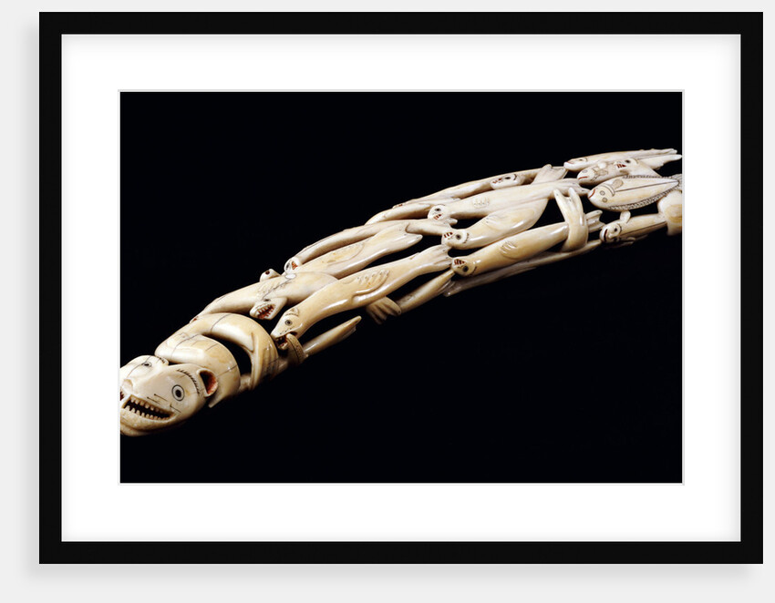 An Eskimo carved walrus ivory tusk with various spirit and animal figures by Anonymous