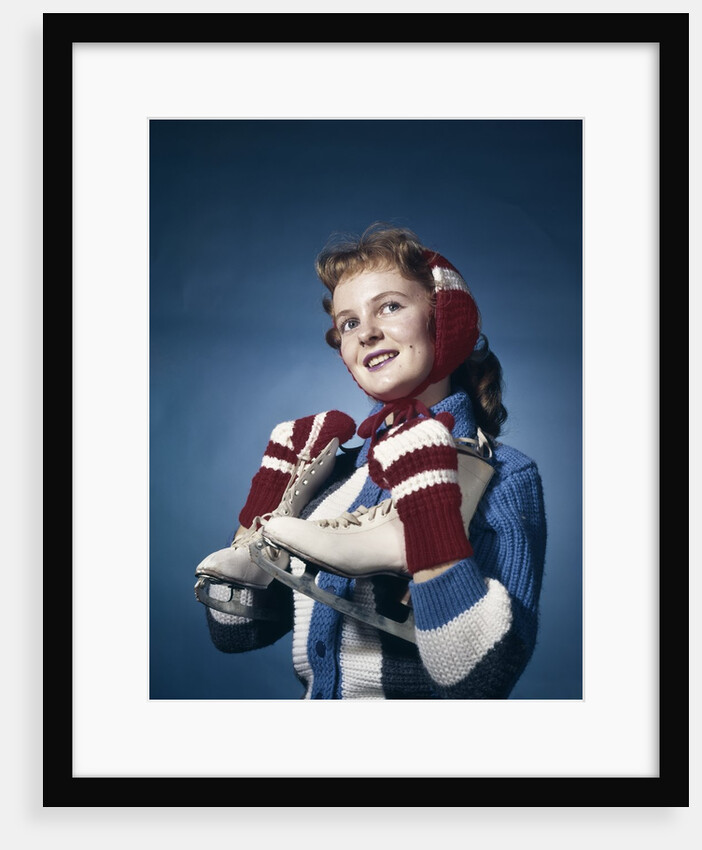 1960s Smiling Woman Wearing Red Mittens Ear Muff Blue Sweater Holding Ice Skates by Anonymous