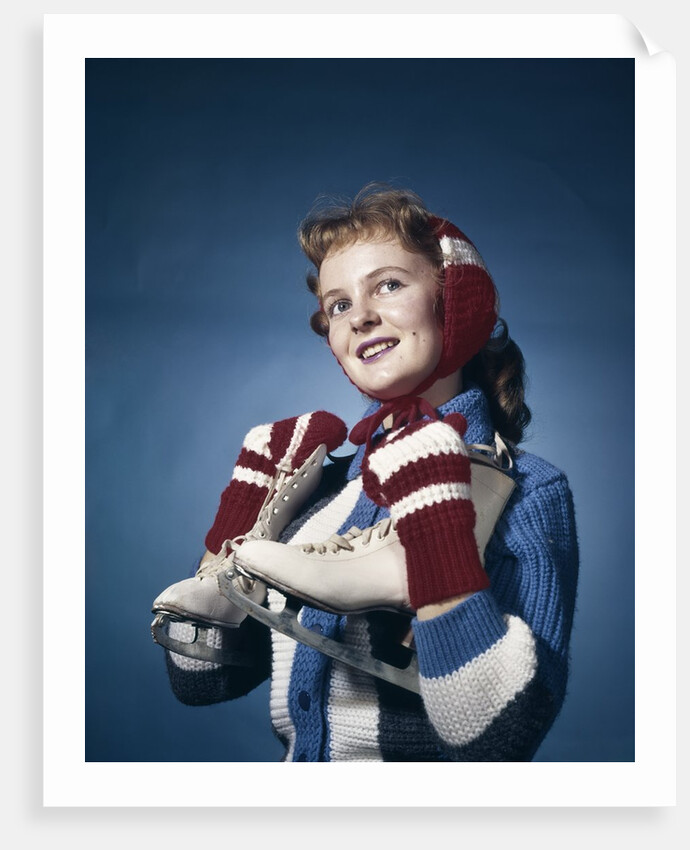 1960s Smiling Woman Wearing Red Mittens Ear Muff Blue Sweater Holding Ice Skates by Anonymous