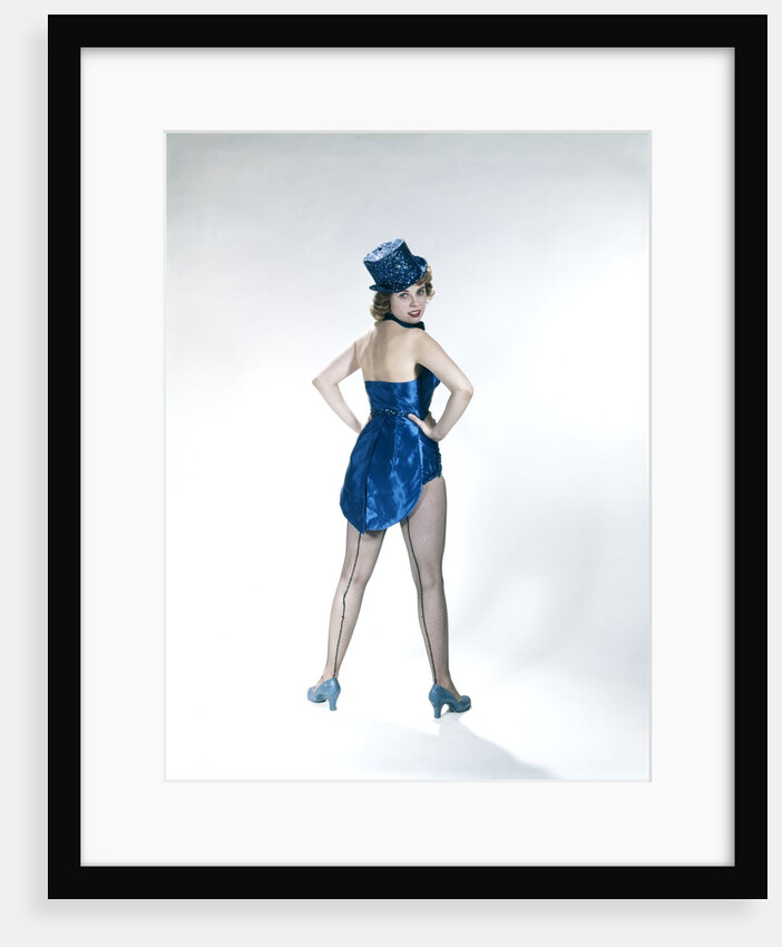 1960s Woman Looking Over Shoulder Wear Dance Costume Blue Sequined Top Hat Silk Tails Fishnet Seamed Stockings Looking At Camera by Anonymous