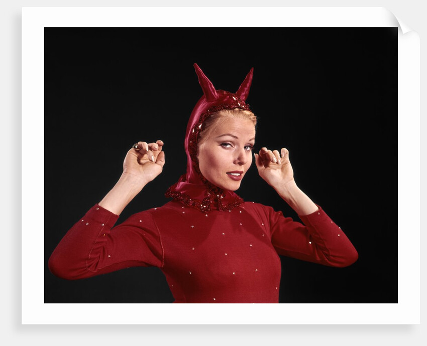 1960s Woman Red Devil Costume With Horns Arms Up In Air Looking Seductively At Camera by Anonymous